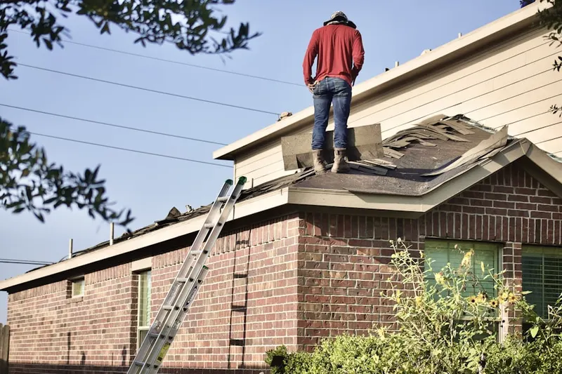 Professional roofer working on a residential roof in North Accokeek
